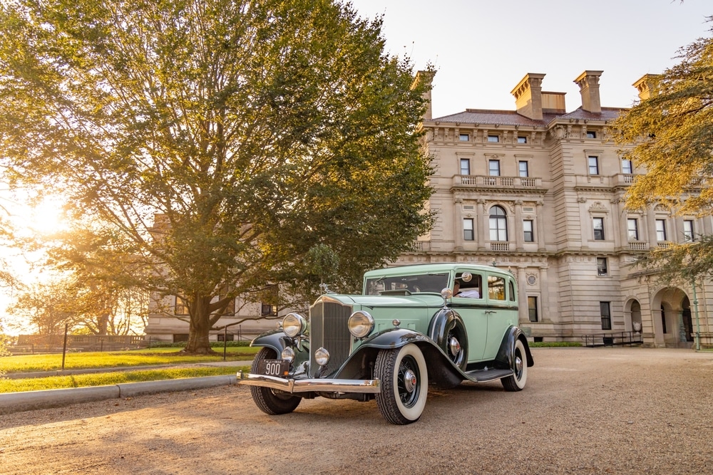 A historic car parked in front of one of the Newport Mansions - a great activity for couples while staying at our Newport RI Bed and Breakfast